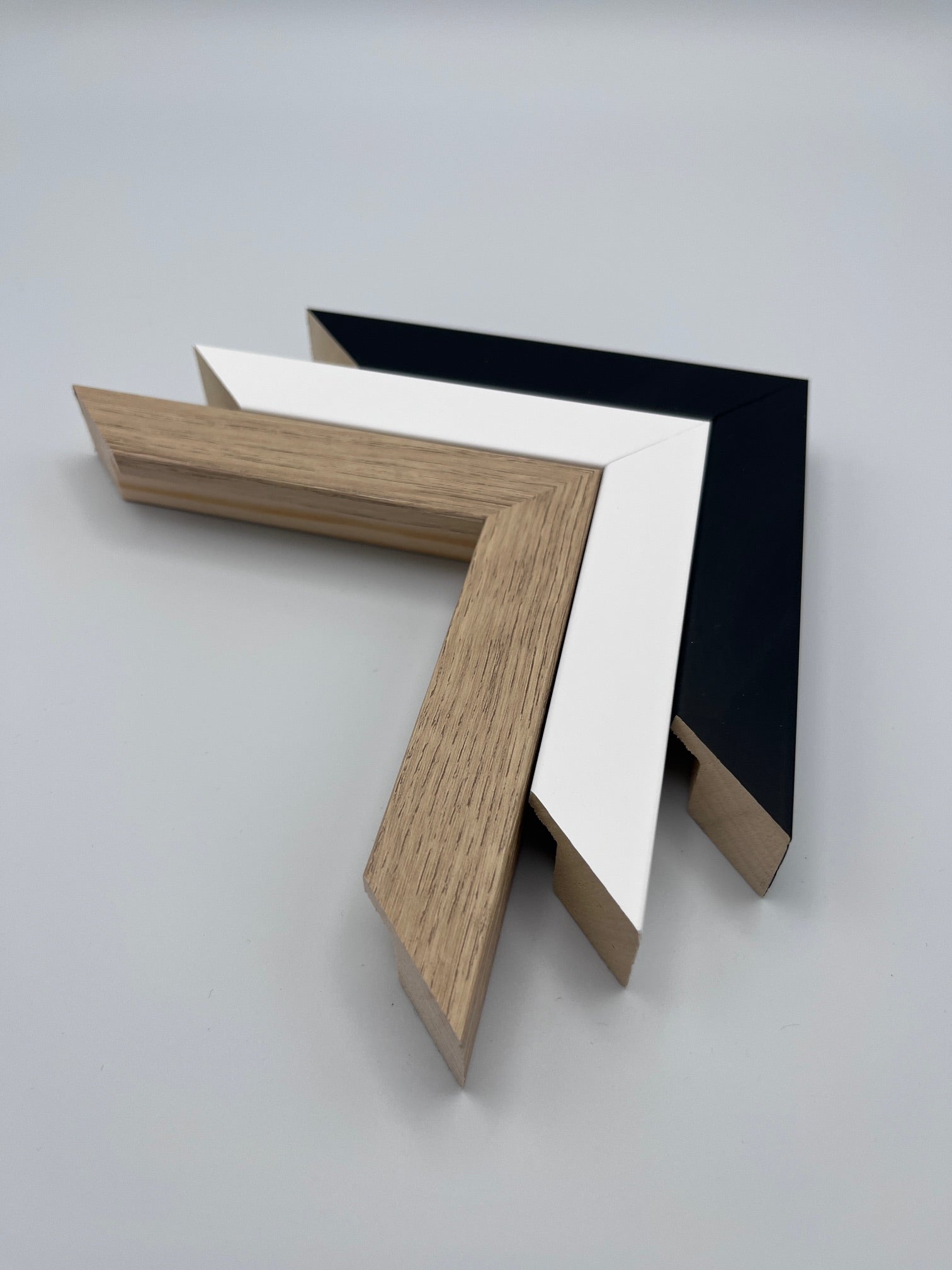 Frame colour options: black, white and natural wood