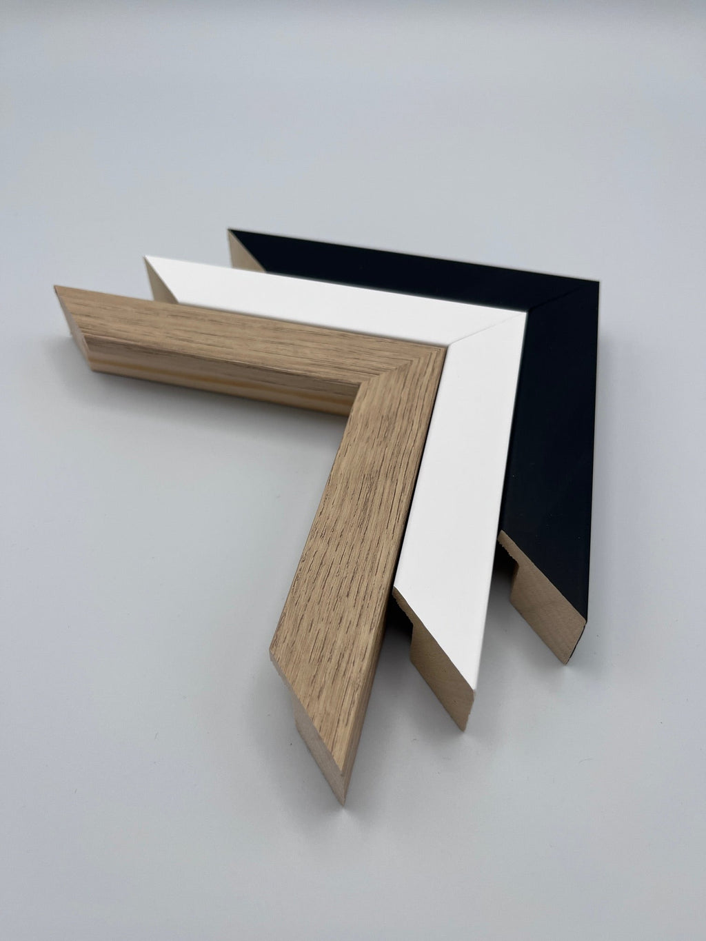 Frame colour options: black, white and natural wood